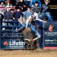 Texan bull rider, Cort McFadden, rides atop a bull named Down to Fly from Dosier Cattle Co in Devner, Colorado at the National Western Stock Show during the Professional Bull Riding for a total of 87 points